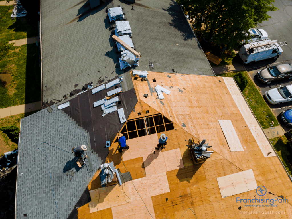 Aerial view of roofing professionals restoring a residential roof using advanced materials