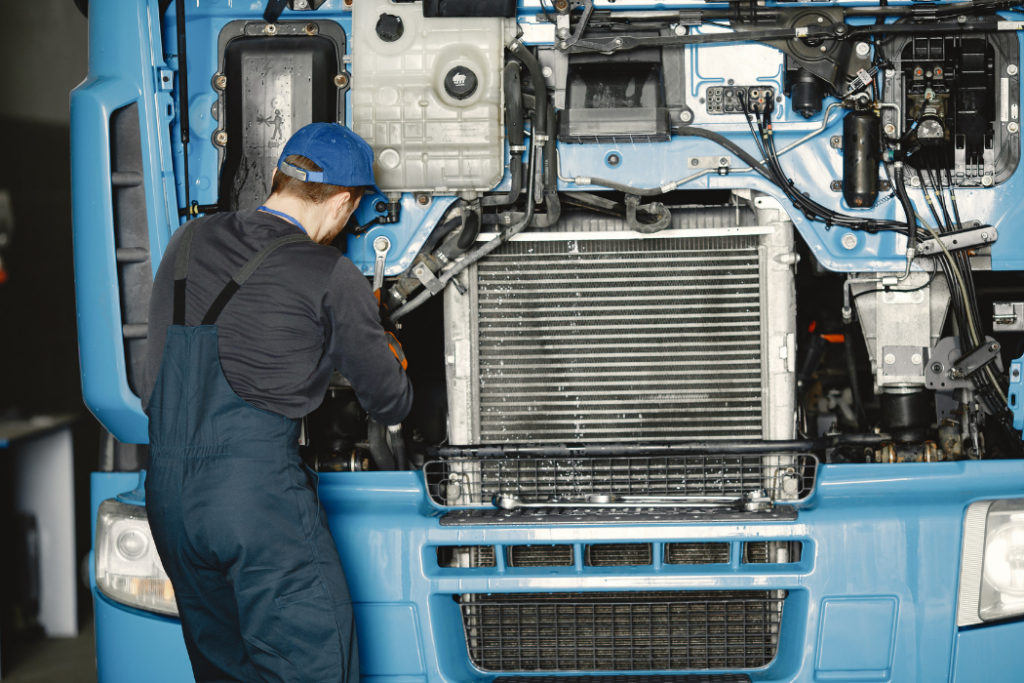 Mobile mechanic performing engine repair on commercial fleet truck